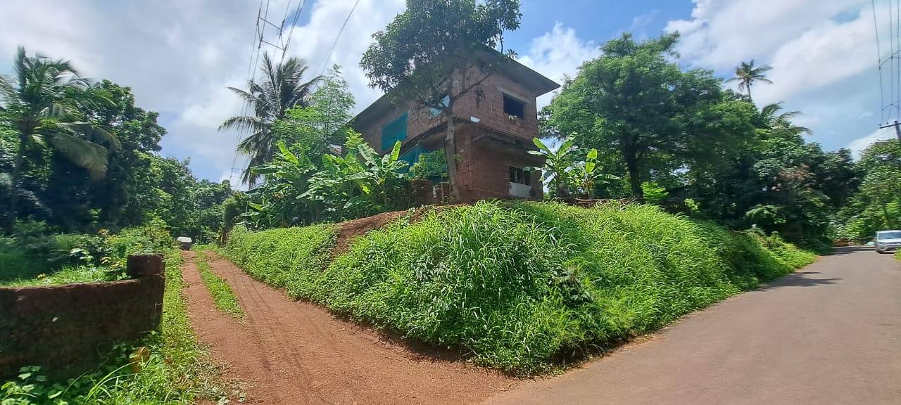 House on the plot beside the access path